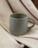 Hand thrown sage green ceramic mug made in Ireland by ceramicist Emily Dillon. Irish pottery