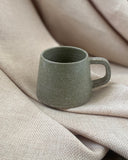 Hand thrown sage green espresso cup with by ceramicist Emily Dillon