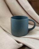 Hand thrown blue ceramic mug made in Ireland by ceramicist Emily Dillon. Irish pottery