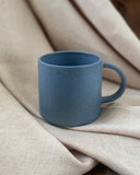 Hand thrown blue ceramic mug made in Ireland by ceramicist Emily Dillon. Irish pottery