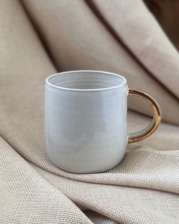 Hand thrown cup with gold lustre by ceramicist Emily Dillon