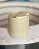 Pale yellow ceramic to-go cup with scallop design