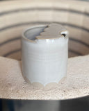 Rustic beige ceramic to-go cup with scallop design