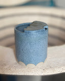 Blue speckled ceramic to-go cup with scallop design